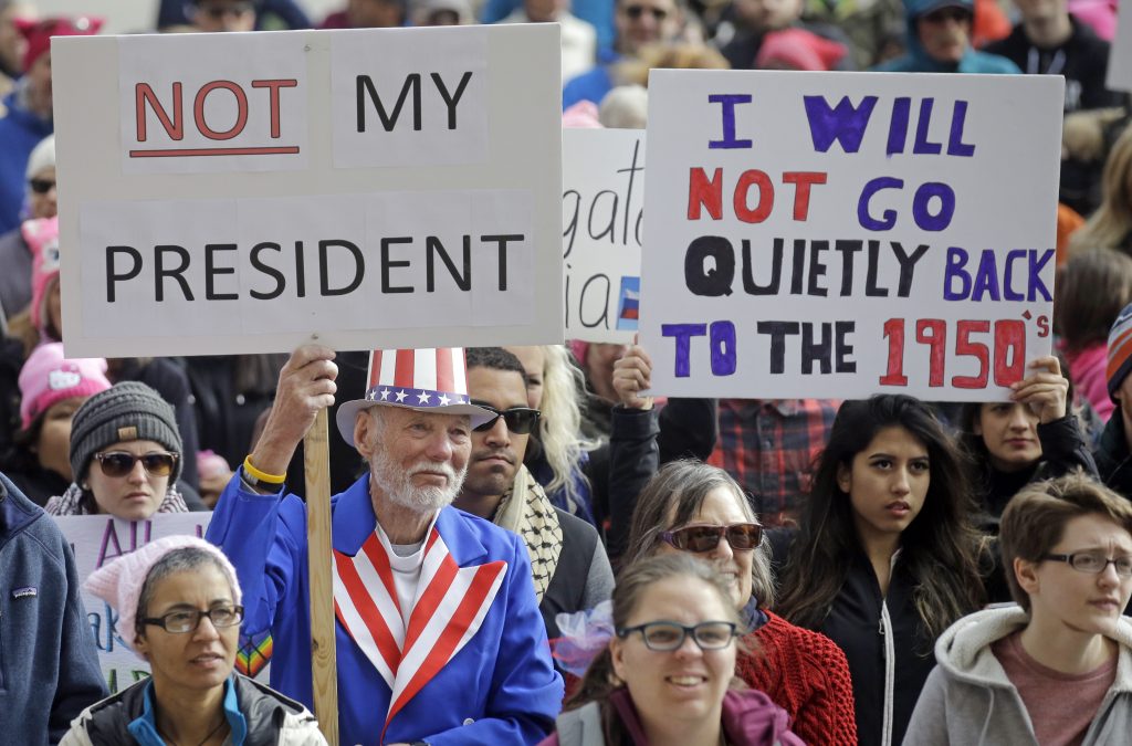 Demonstrators hold a rally Monday, Feb. 20, 2017, in Salt Lake City. The rally is one of several Not My Presidents Day protests planned across the country to mark the Presidents Day holiday. Protesters are criticizing President Donald Trump's immigration policies, among other things. (AP Photo/Rick Bowmer)