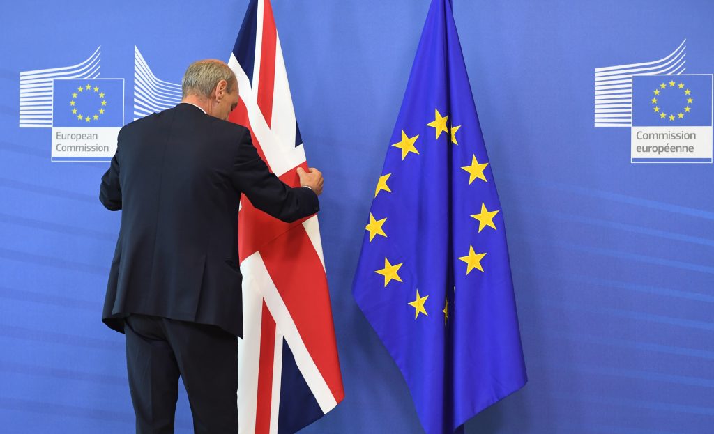 A member of protocol adjusts the British flag prior to the arrival of British Prime Minister David Cameron at EU headquarters in Brussels on Tuesday, June 28, 2016. EU heads of state and government meet Tuesday and Wednesday in Brussels for the first time since Britain voted to leave the European Union, throwing British and European politics into disarray.