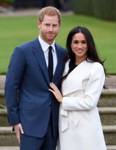 Britain's Prince Harry and Meghan Markle pose for the media in the grounds of Kensington Palace in London, Monday Nov. 27, 2017. It was announced Monday that Prince Harry, fifth in line for the British throne, will marry American actress Meghan Markle in the spring, confirming months of rumors. (Eddie Mulholland/Pool via AP)