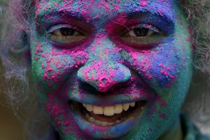 A girl's face is smeared in color as she celebrates Holi, the Hindu festival of colors, in Mumbai, India, Friday, March. 2, 2018. (AP Photo/Rajanish Kakade)