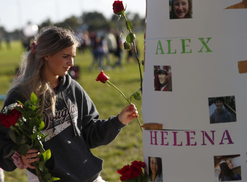 Students decorate posters to remember the students killed at the vigil in Parkland. (AP Photo/Wilfredo Lee)