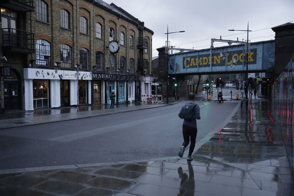 A man jogs in Camden Town, an area of London usually bustling with tourists and visitors to its market.