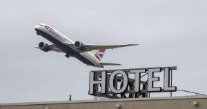 Plane passing over the Sofitel Hotel at Heathrow. Travellers from the UK's "red list" countries will have to quarantine in hotels for 10 days.